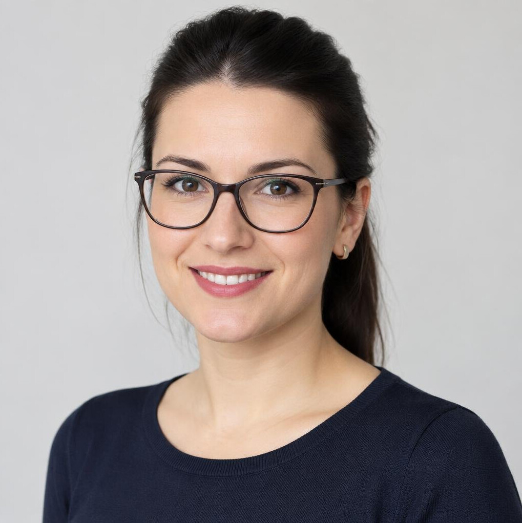 Studio portrait of a smiling woman with glasses