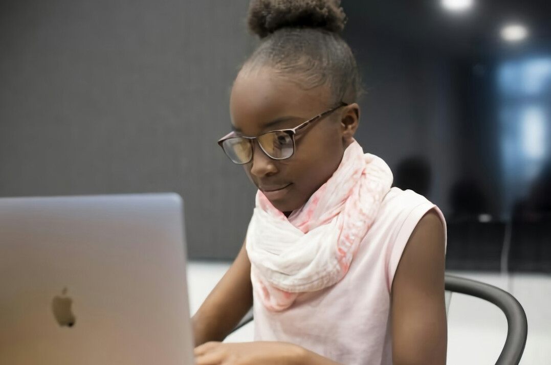young person learning to code on laptop